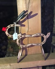 a pair of scissors on top of a piece of wood