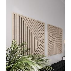 two wooden panels on the wall above a plant