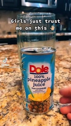 someone is holding a glass with pineapple juice in it and the caption reads, girls just trust me on this