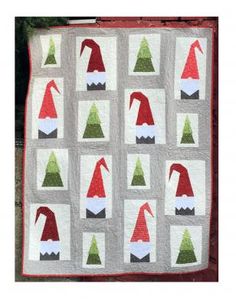 a quilted christmas scene with santa hats on it