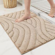 a person standing on top of a bathroom rug