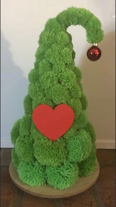 a green christmas tree with a red heart on it