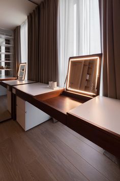 a desk with a lighted mirror on top of it