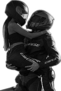 two people in helmets hugging each other on a motorbike, black and white photograph