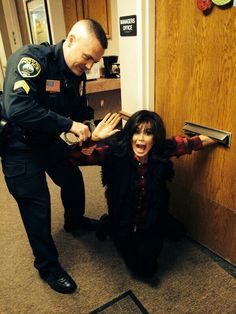 a police officer helping a woman into her room