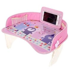 a child's desk with a cell phone on it and an animal print cover