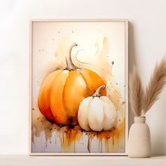 an orange and white pumpkin sitting on top of a shelf next to a vase filled with feathers