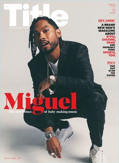 a man sitting on top of a magazine cover wearing a black suit and white sneakers