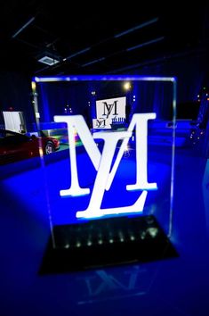 an illuminated glass block with the letter m on it