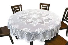 a white table cloth on top of a wooden table with four chairs and a bench