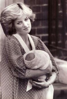 an old photo of a woman holding a stuffed animal in her arms and looking at the camera