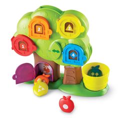 a toy tree house with lots of toys around it on a white background for use in children's playrooms