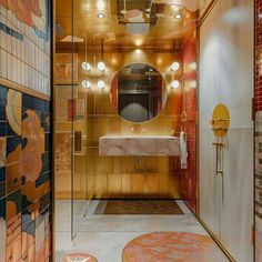 the bathroom is decorated in gold and red tiles with mirrors on the wall, along with round stools