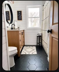 a bathroom with black and white tile flooring