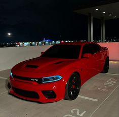 a red sports car parked in a parking lot