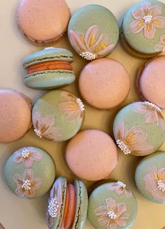 macaroons decorated with flowers and pearls on a plate