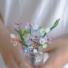 a vase filled with flowers sitting on top of a table