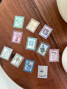 some stamps are sitting on a wooden table