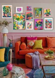 a living room filled with colorful furniture and pictures on the wall above it's coffee table