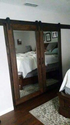 a bedroom with mirrored closet doors in it