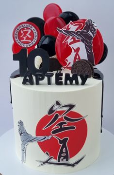 a white cake with red and black decorations