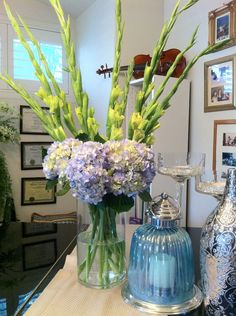 two vases filled with flowers on top of a table