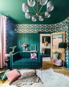 a living room with green walls and floral wallpaper