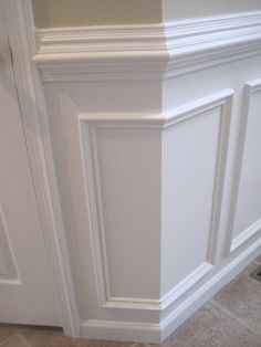 the corner of a room with white paneling