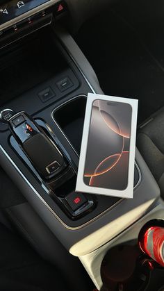 a cell phone sitting on the center console of a car