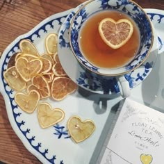 a cup of tea and some orange slices on a plate