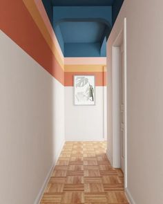 an empty hallway painted in blue, orange and pink with a painting on the wall