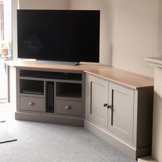 a flat screen tv sitting on top of a wooden cabinet