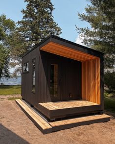 a small wooden structure sitting on top of a dirt field