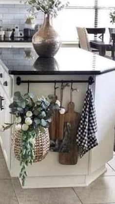 a kitchen island with pots and pans hanging from it's hooks on the wall