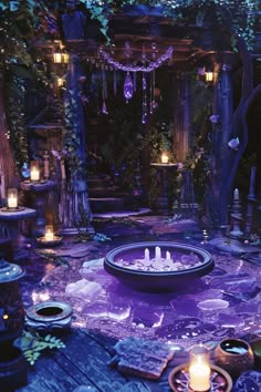 a purple fountain surrounded by candles and trees