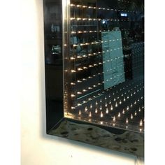 a large mirror with lights on it in a room