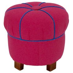 a pink ottoman with blue piping on the top and legs, sitting in front of a white background