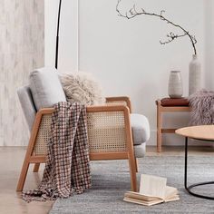 a living room with two chairs and a book on the floor next to each other