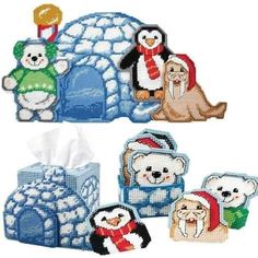 four different types of tissue holders with animals and polar bears in the snow on them