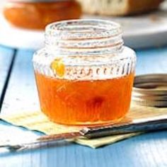 a jar filled with honey sitting on top of a table