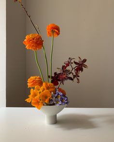 an arrangement of flowers in a white vase