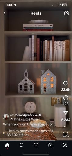 a book shelf filled with books next to a clock