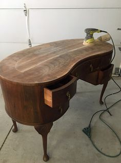 a wooden desk with two drawers and an ironing board attached to the table top