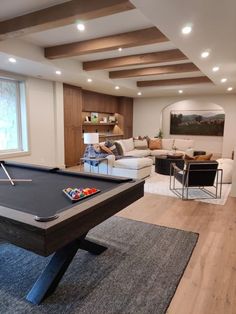 a pool table in the middle of a living room