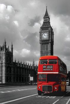 a red double decker bus driving past the big ben clock tower in london, england