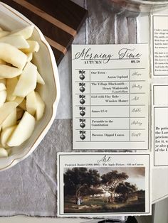 a table topped with lots of food next to a bowl of potatoes and other items