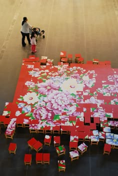 an overhead view of tables and chairs with flowers on the floor in front of them