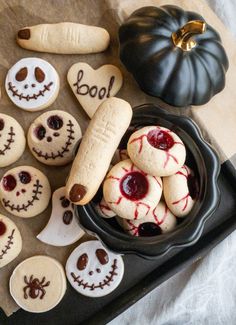 halloween cookies decorated like jack - o'- lanterns and pumpkins on a tray