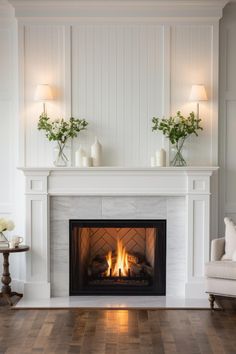 a fireplace with white walls and wood floors