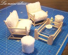 three chairs and a table made out of wood with fake fur on the top one